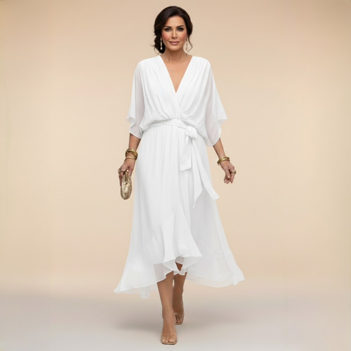 Model walking in the white chiffon midi dress with draped V-neck, bow at the waist and flowing ruffled asymmetric hem. 6