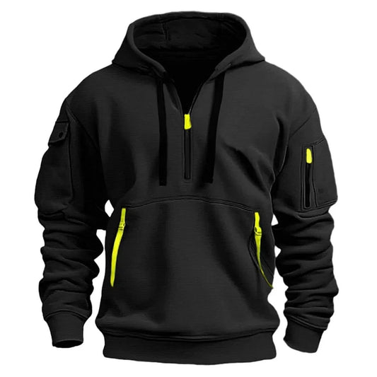 Black hooded top, front view, with bright yellow-green zip pulls and pocket tabs and a zipped sleeve pocket 2