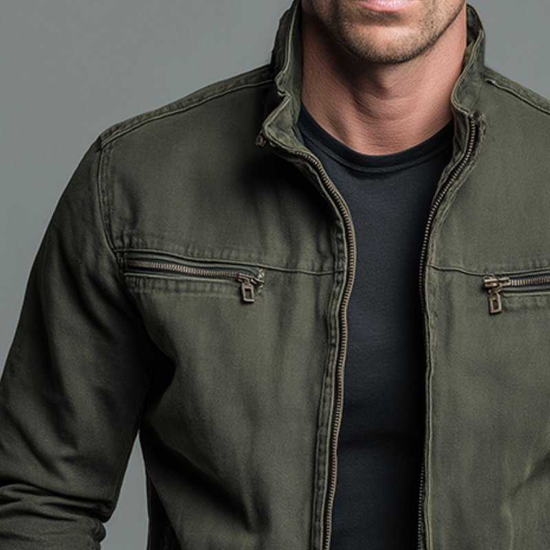 Close-up of the olive green jacket's stand collar, front zip and zipped chest pockets with bronze-toned pullers 4