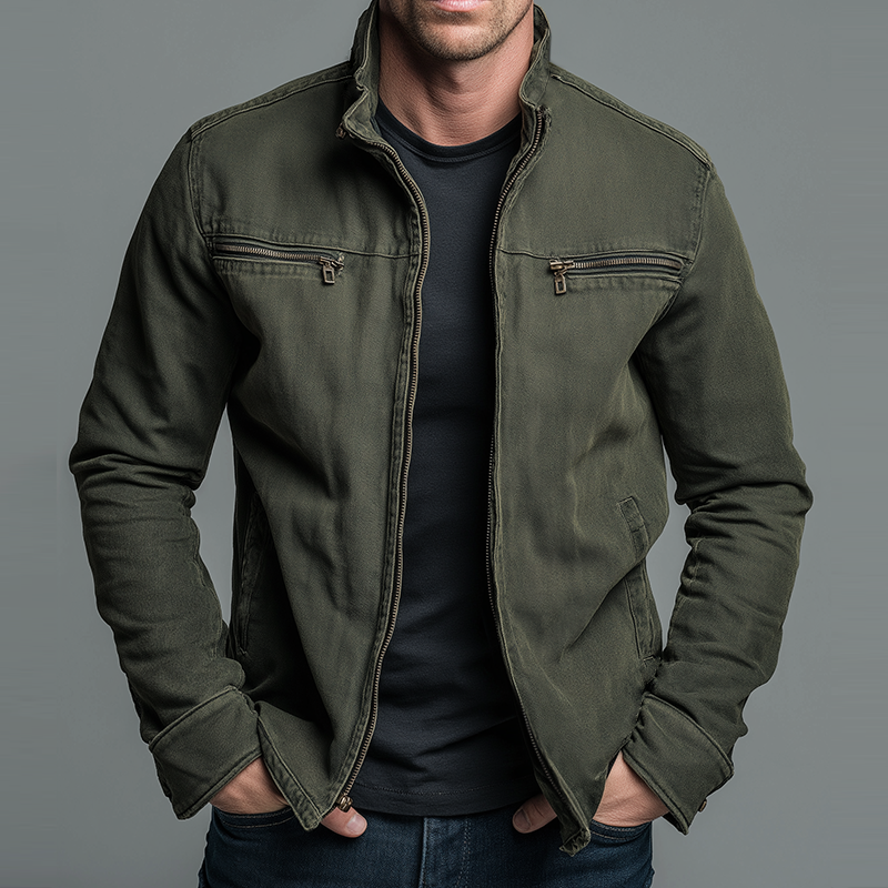 Olive green washed jacket worn open over a black tee, hands in pockets, grey backdrop 2
