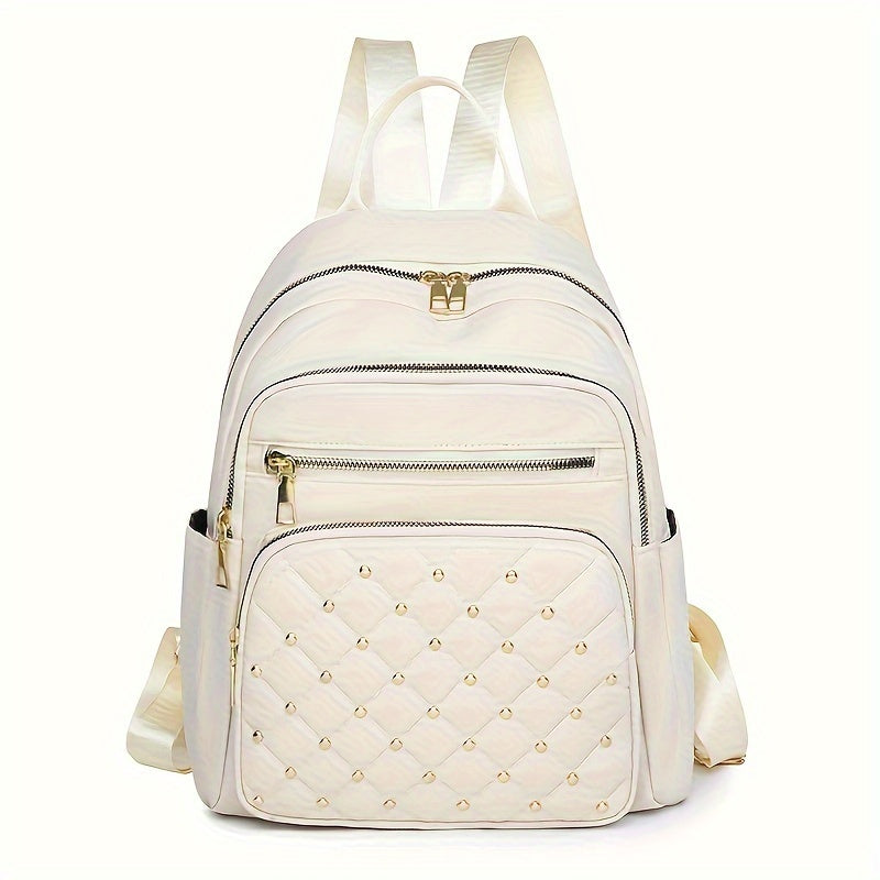 Cream backpack front view with a quilted, gold-studded front pocket and gold zip pulls 13