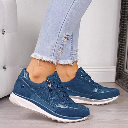 Blue version of the lace-up trainers with side zip and studded panel, worn with ripped light-blue jeans. 3