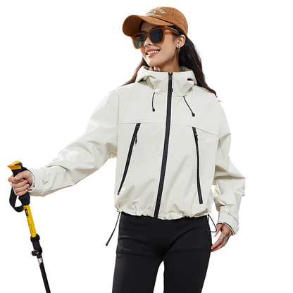 Smiling woman in the cream jacket with cap and sunglasses, holding a yellow trekking pole 3