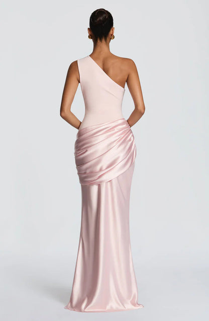 Back view of the blush pink dress, showing the sloped back neckline and draped satin across the hips. 20