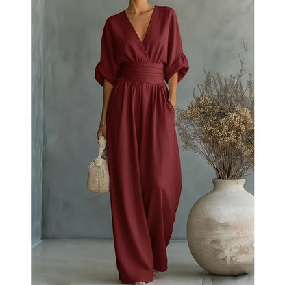 Burgundy jumpsuit in a closer front crop, showing the V-neck, wide waist band and loose wide legs. 8