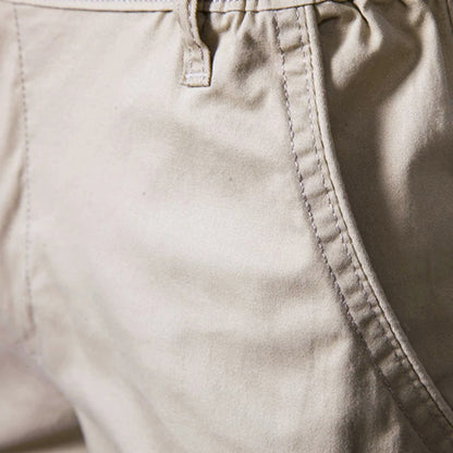 Close-up of beige fabric showing the side pocket opening with contrast stitching and a belt loop 3