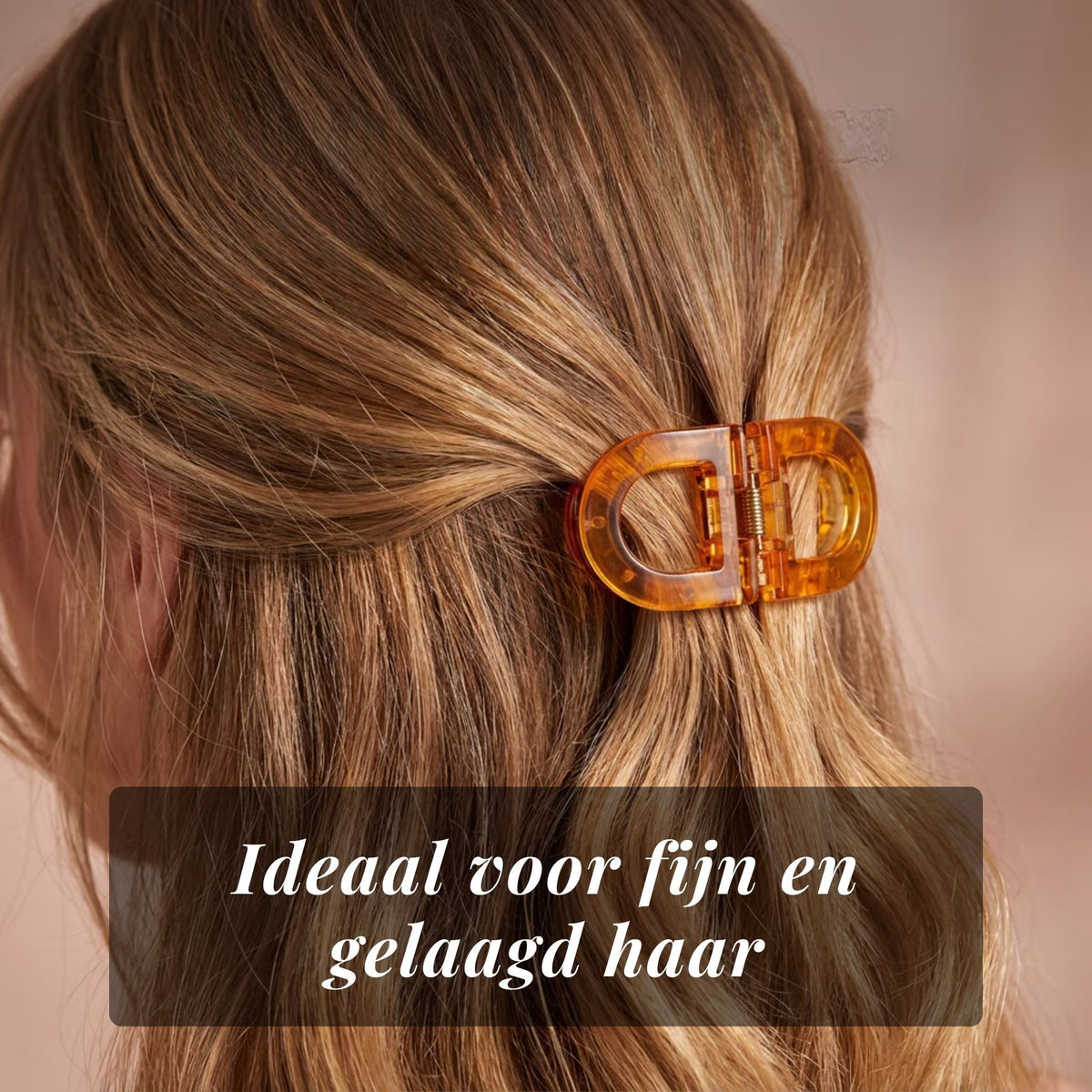 Close-up of the amber flat clip holding fine, layered blonde hair at the back of the head. 9