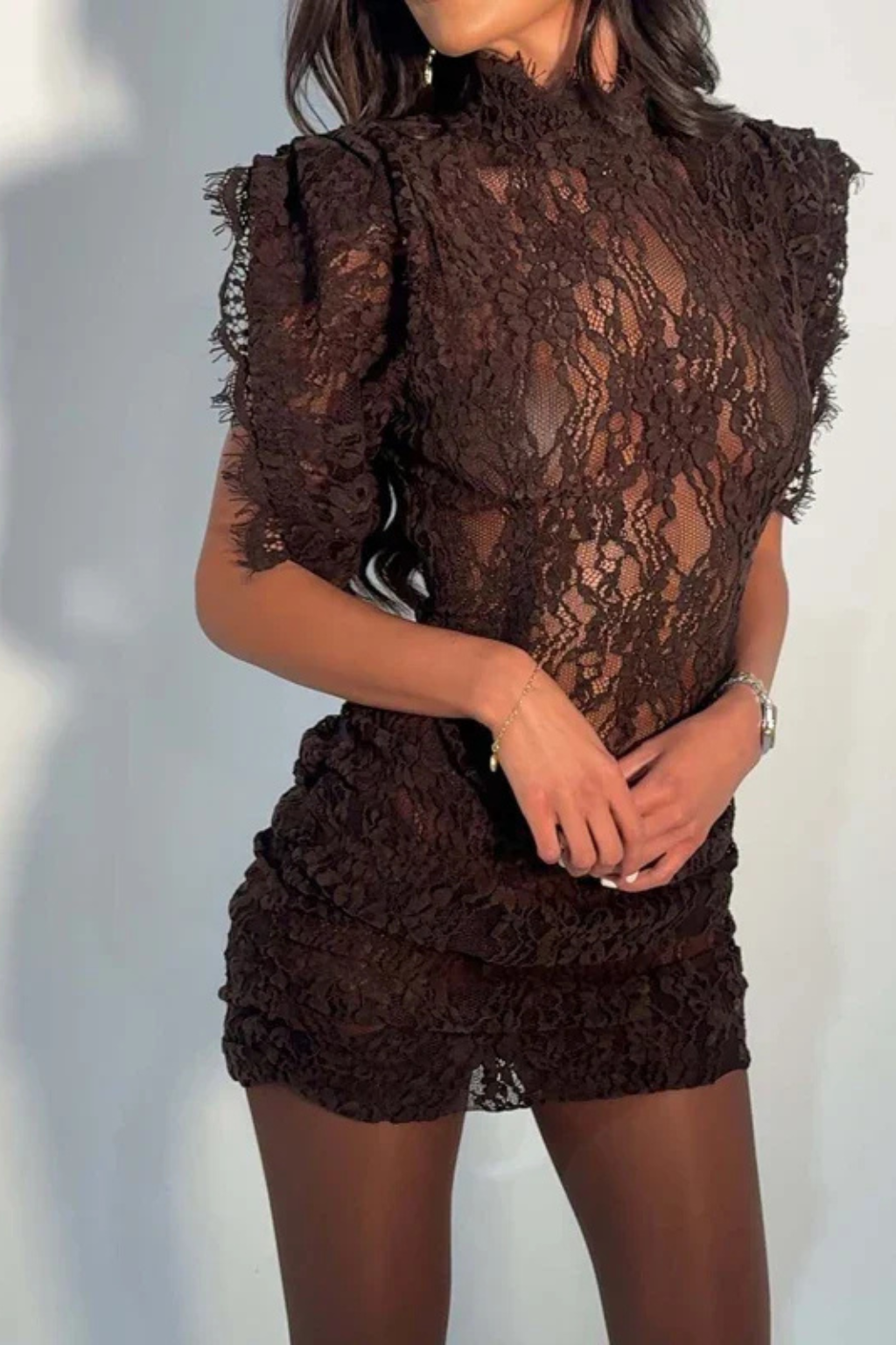 Cropped view of the brown lace dress, showing the sheer bodice and gathered, ruched mini skirt 7