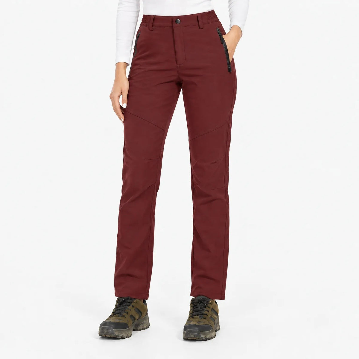 Front view of the trousers in a deep burgundy red, worn with hiking boots 4