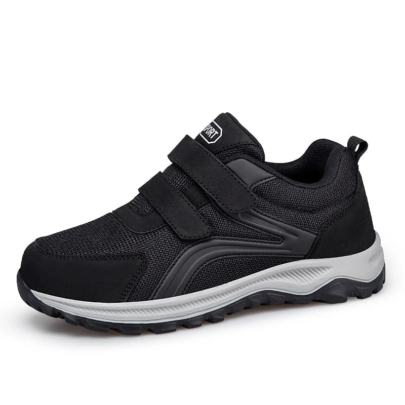 Single black strap shoe with grey sole, angled front view on a white background 15