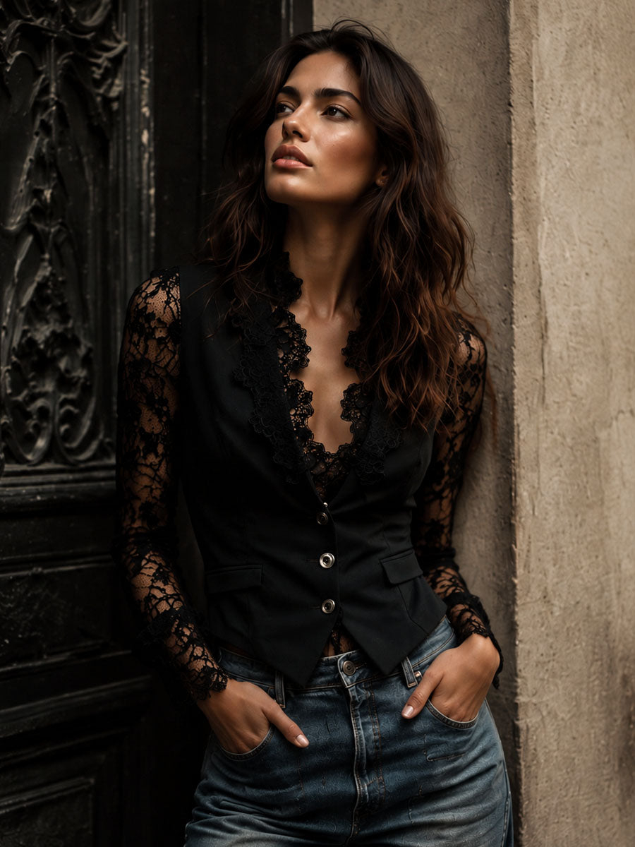 Model leaning against a stone wall beside a dark carved door, wearing the black lace-sleeved jacket with jeans 2