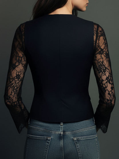 Back view of the black jacket, showing plain structured back panels, a centre seam and sheer lace sleeves 12