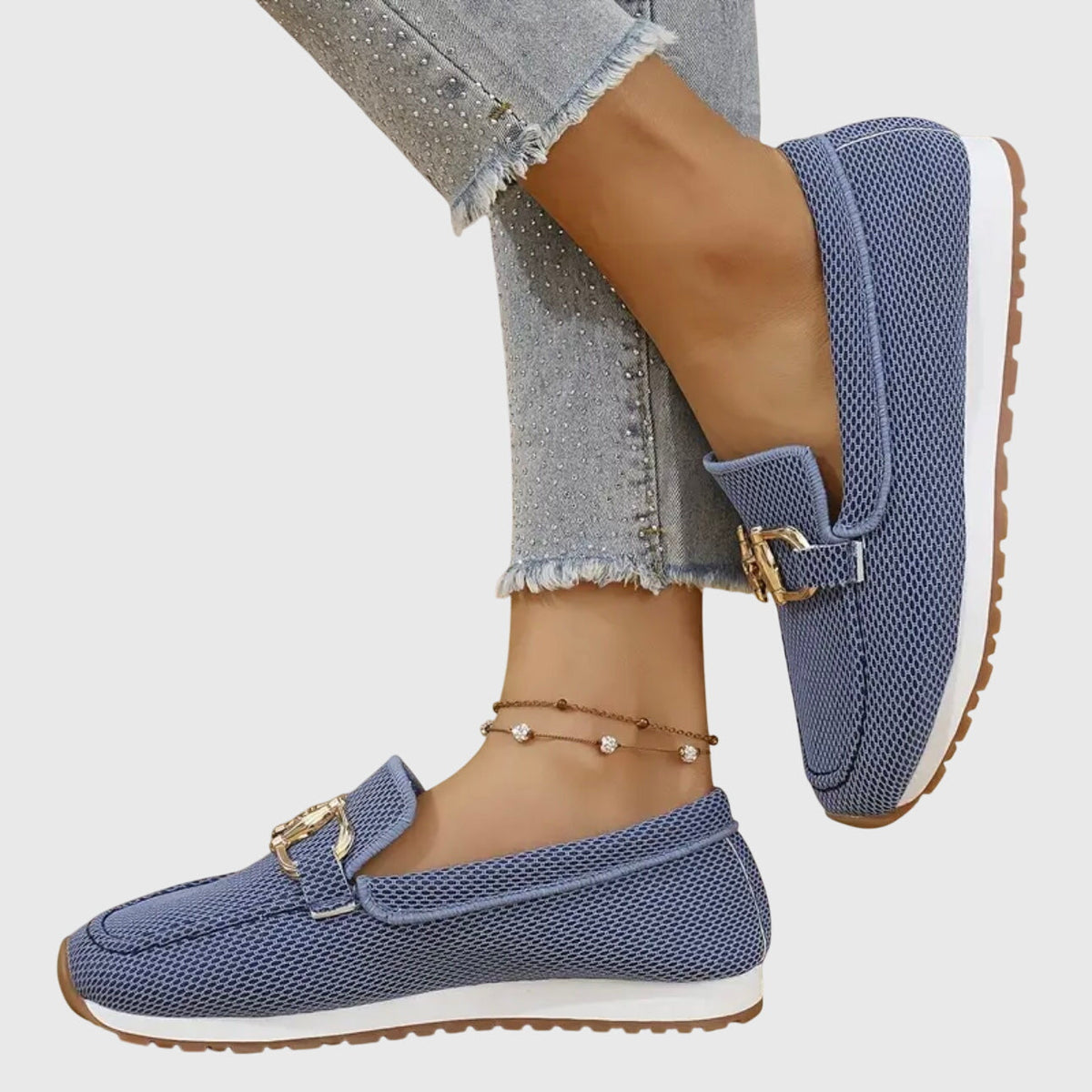 Blue mesh loafers worn by a model, one foot raised to show the side and sole 7