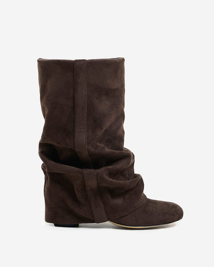 Side view of a single dark brown suede-look boot with a slouchy, gathered shaft, rounded toe and low hidden heel. 1