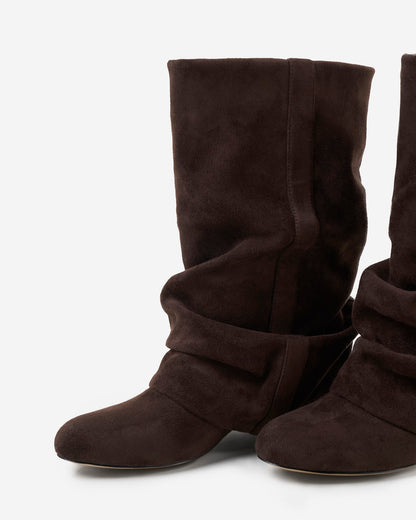 Angled close-up of the pair showing the rounded toe, gathered ankle folds and stitched strap detail on the shaft. 6