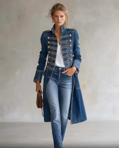 Full-length front view of the blue denim coat worn open over a white top and jeans against a plain studio wall. 4