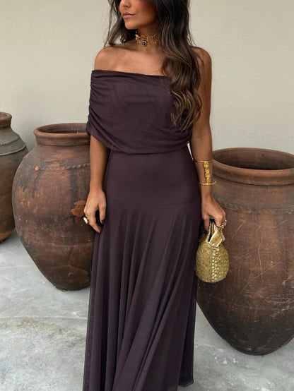 Dark brown one-shoulder draped bodice and flared skirt, shown from waist down with a gold beaded bag 12