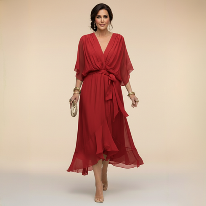 Model wearing the red chiffon midi dress with draped V-neck, sheer flared sleeves, waist sash tied in a bow and ruffled hem. 7