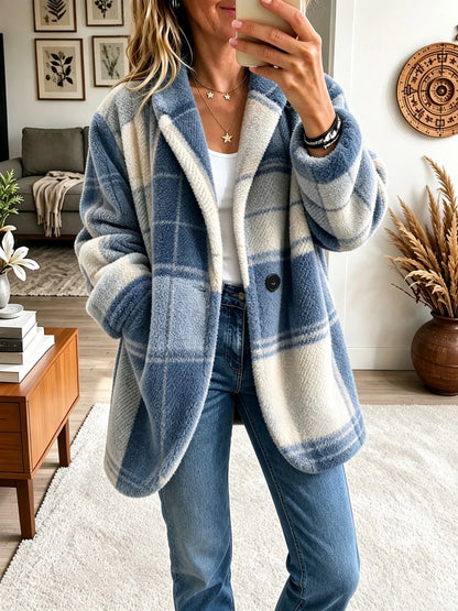 Model wearing the teddy-style fleece coat in a soft blue and cream check, worn open over a white top and jeans. 8
