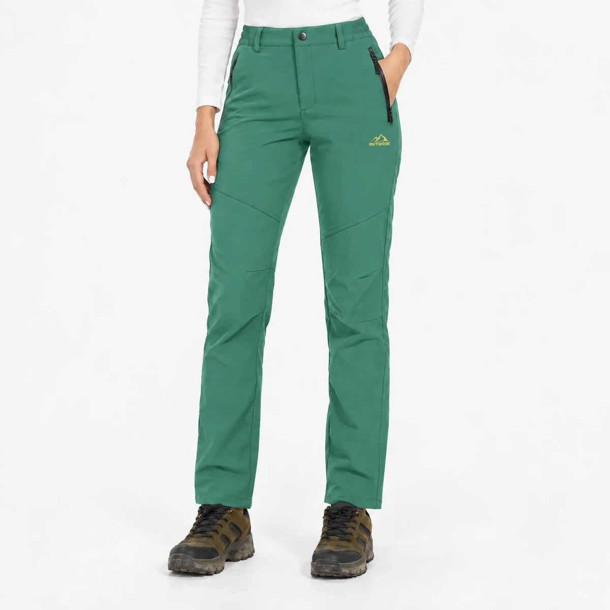 Front view of the trousers in a mid green, worn with a white long-sleeved top 13
