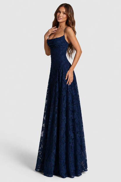 Navy lace gown seen from the side, model looking over her shoulder with one hand at her chest. 13