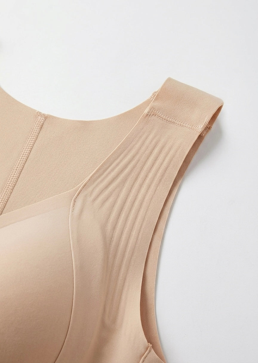 Flat close-up of the beige bra's wide ribbed shoulder strap, stitching and smooth fabric 10