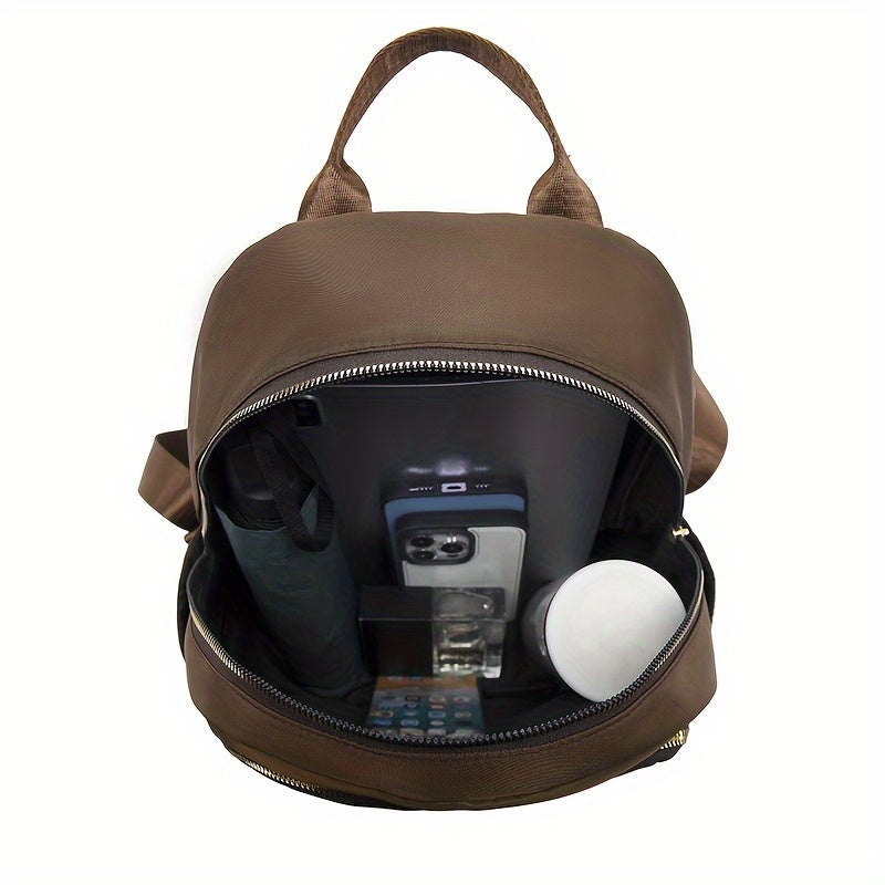 Brown backpack opened from above, showing the roomy lining holding a tablet, phone, umbrella and small items 18