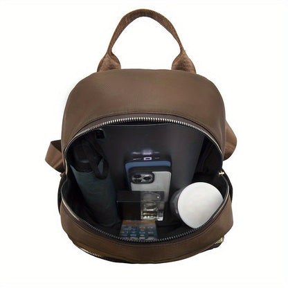 Brown backpack opened from above, showing the roomy lining holding a tablet, phone, umbrella and small items 18