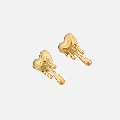 Gold-tone dripping heart earrings photographed at an angle, showing their rounded shape and glossy drips 2