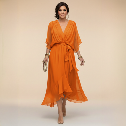Model in the bright orange chiffon midi dress with gathered V-neck bodice, tied waist and layered ruffled skirt, gold bangles on both wrists. 8