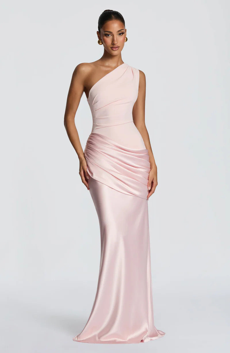 Angled view of the blush pink dress, showing the shine of the satin skirt and ruched hip detail. 19