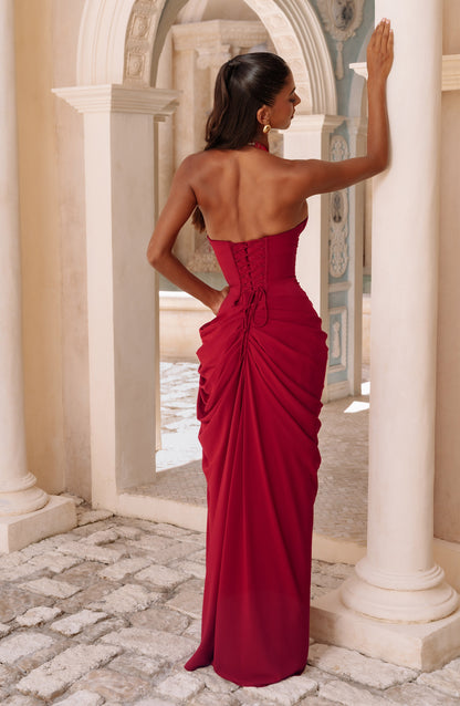 Back view of the red dress on a model, showing the lace-up corset back and gathered, draped chiffon skirt. 23