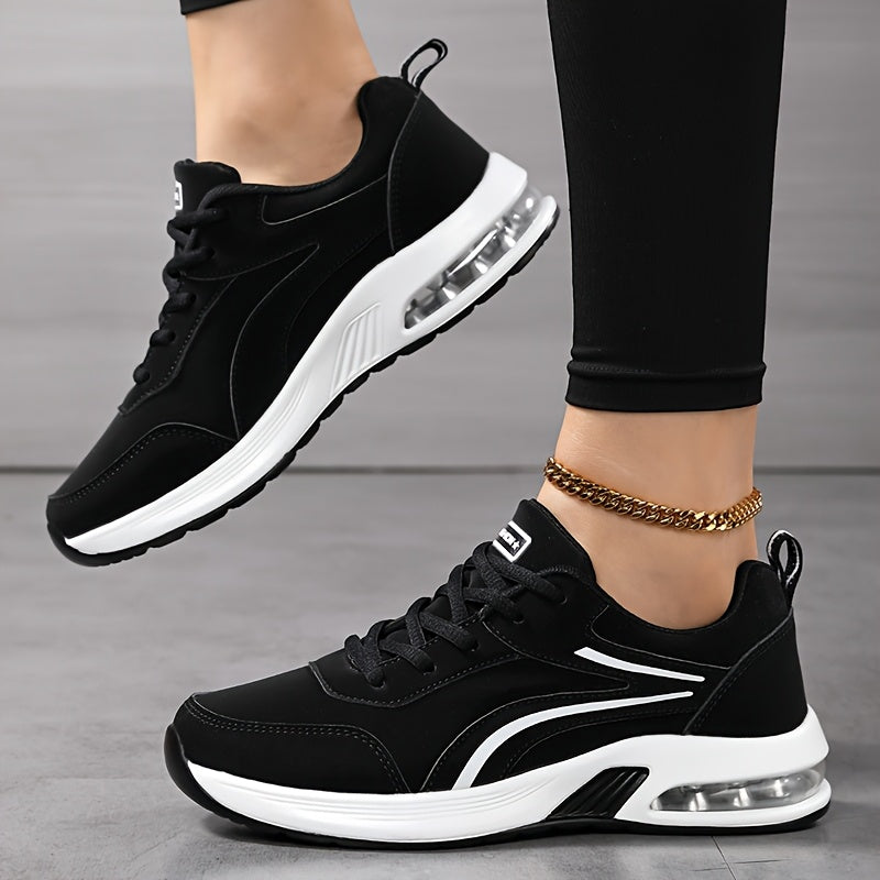 Side view of black trainers on a model, one foot raised to show the white air-cushion sole 3