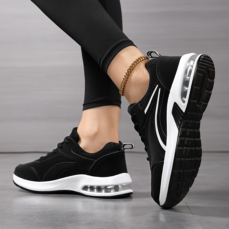 Model with feet crossed showing the black treaded outsole and white air-cushion midsole of the trainers 4