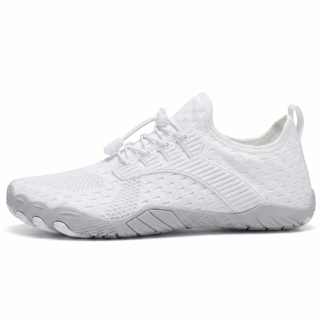 Side view of a white knit barefoot trainer with elasticated toggle laces, pull tab and grey flexible sole with moulded toe pods. 1