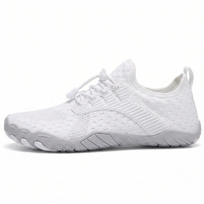Side view of a white knit barefoot trainer with elasticated toggle laces, pull tab and grey flexible sole with moulded toe pods. 1