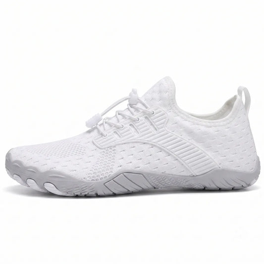 Side view of a white knit barefoot trainer with elasticated toggle laces, pull tab and grey flexible sole with moulded toe pods. 1