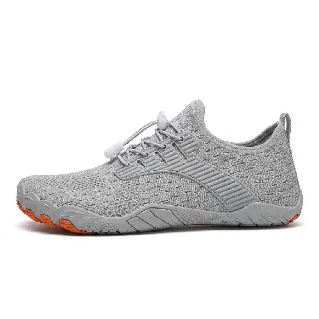 Side view of a light grey knit barefoot trainer with toggle laces, grey sole and orange toe tips on the outsole. 10
