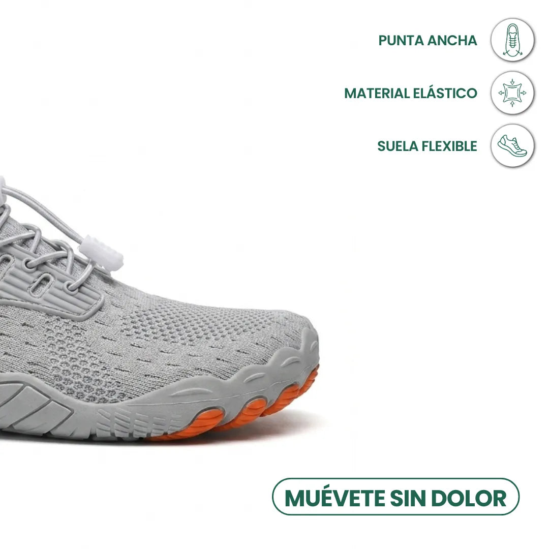 Close-up of the wide toe area of a grey trainer with orange sole tips and icons for roomy toe, stretch and flexibility. 14