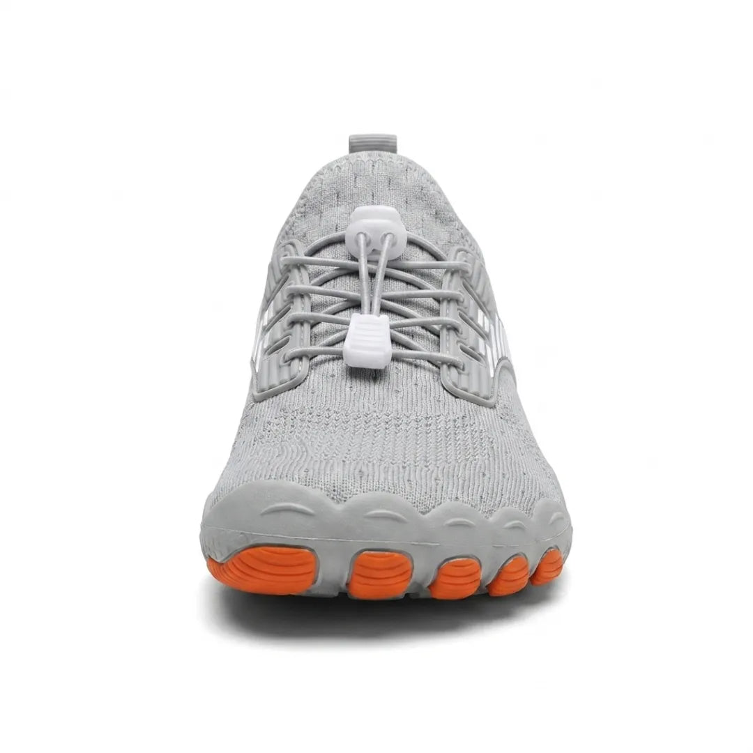 Front view of a grey trainer showing the broad rounded toe, white toggle laces and orange toe pads on the sole. 17