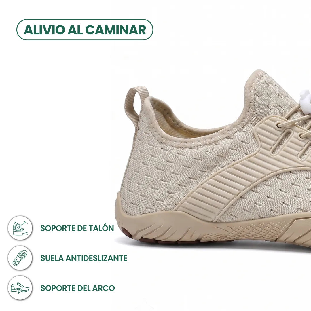 Heel and side close-up of a beige knit trainer showing the pull loop, ribbed overlay, grippy sole and graphic icons. 22