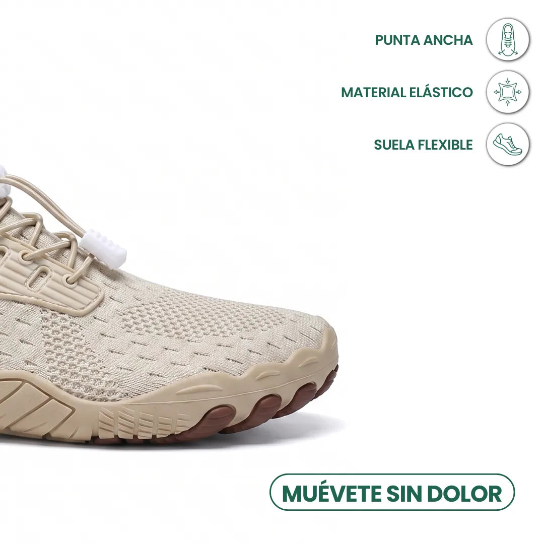 Toe-end close-up of a beige knit trainer showing the wide rounded toe, elastic toggle laces and flexible sole. 23