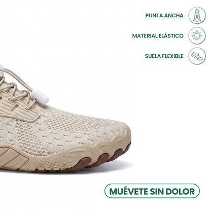 Toe-end close-up of a beige knit trainer showing the wide rounded toe, elastic toggle laces and flexible sole. 23