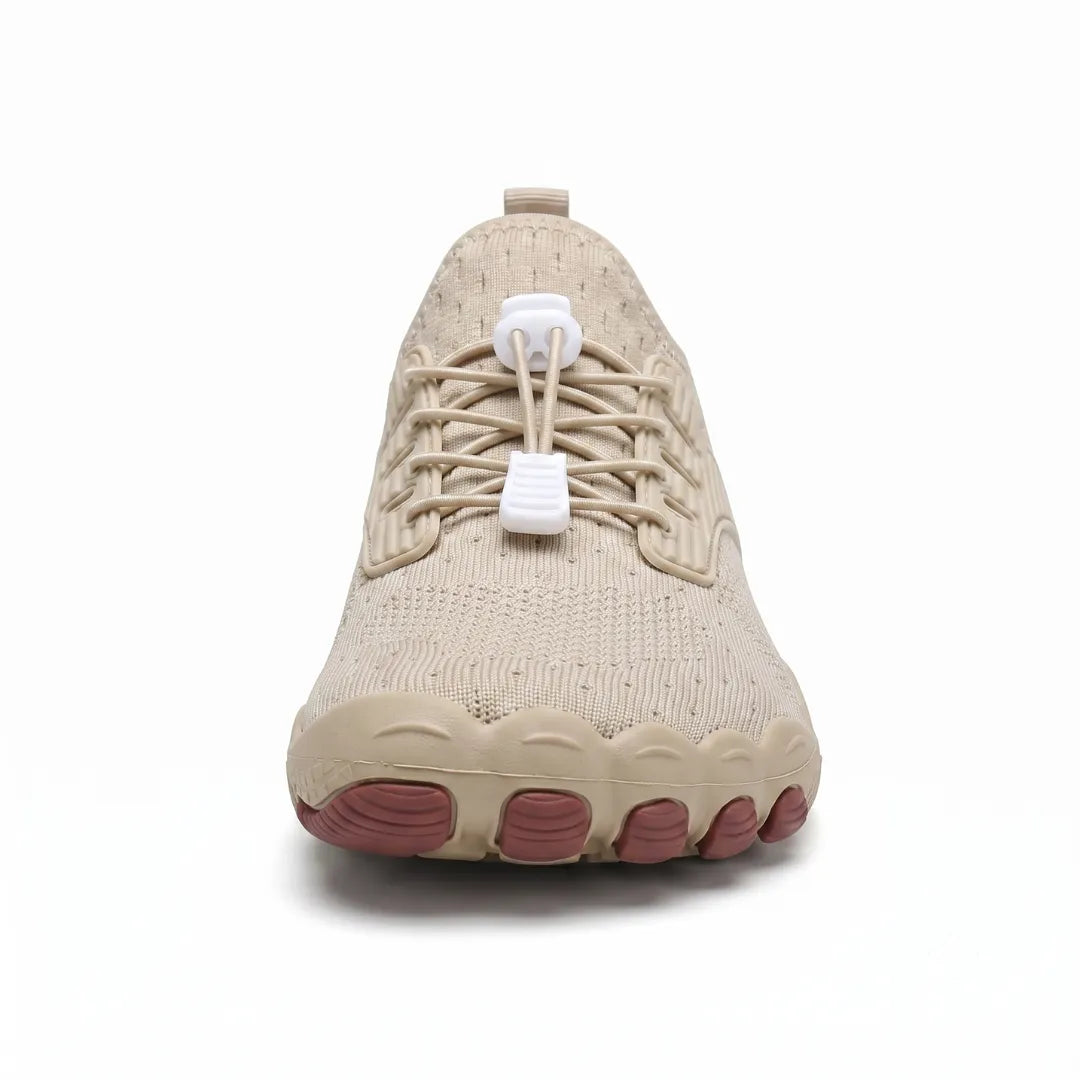 Front view of a beige barefoot trainer showing the wide toe box, elastic laces with white toggles and brown toe-shaped sole pads. 26