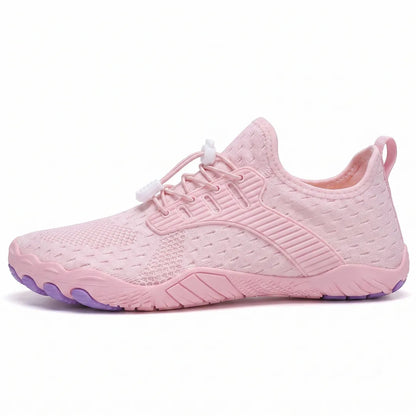 Side view of a pink knit trainer with white toggle laces, ribbed overlay and a purple-tipped flexible sole. 28