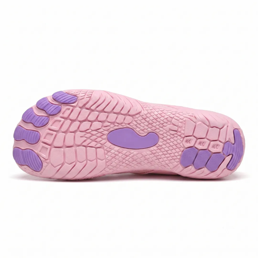Underside of a pink trainer showing the textured tread, separate purple toe pads and a central purple grip patch. 36