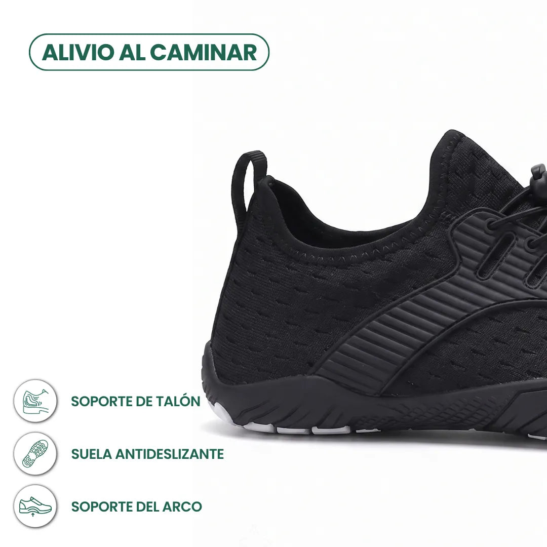 Heel and side close-up of a black knit trainer showing the pull loop, ribbed overlay, grippy sole and graphic icons. 40