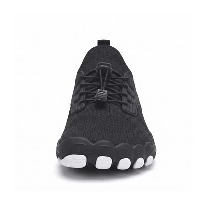 Front view of a black knit trainer showing the broad, foot-shaped toe box with white sole tips and toggle laces. 44