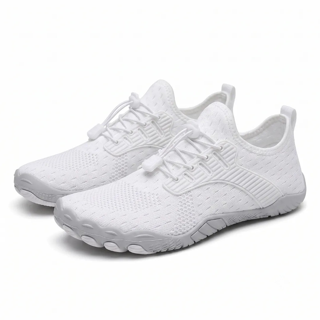 Pair of white knit barefoot trainers seen at an angle, showing elasticated laces and wide, rounded grey toe sole. 7
