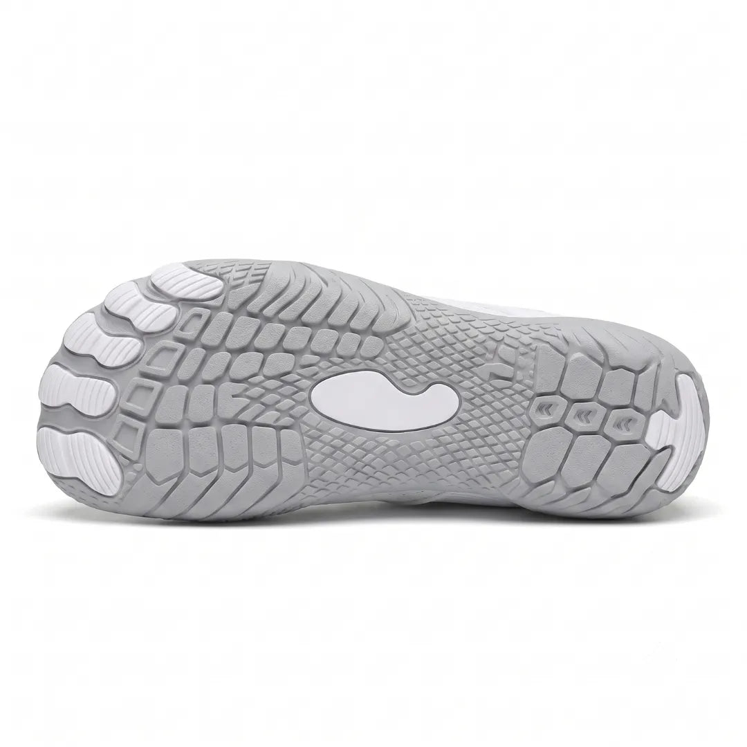 Underside of a white trainer showing the grey tread pattern with white toe pads and a central white panel. 9